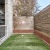 a dog run with a wooden fence